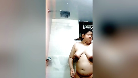 Chubby brunette shows off her ass and tits in the shower