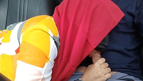 Indian girl in a red dress and sexy stockings in the car