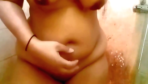 Busty Indian whore is in the bathroom playing with her pussy