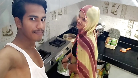 Indian bhabhi cooking in the kitchen with a small outfit