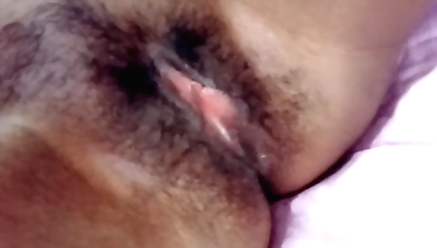 Indian girl showing hairy pussy for a camera in a bedroom